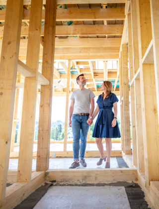 couple walking through new home construction